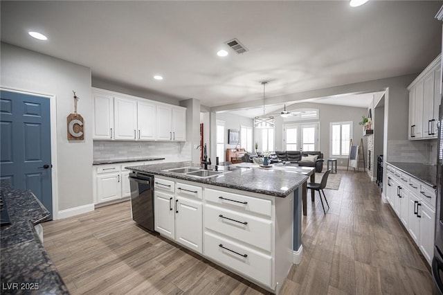 5815 Pristine Falls Ave, Las Vegas, NV 89131 - kitchen with a sink, open floor plan, black dishwasher, ceiling fan, and tasteful backsplash