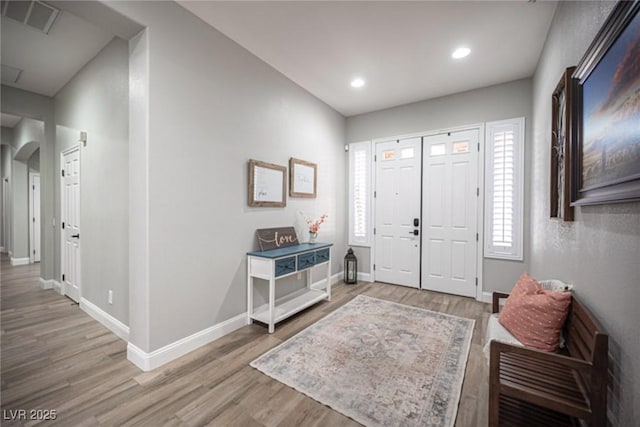 5815 Pristine Falls Ave, Las Vegas, NV 89131 - entryway featuring arched walkways, light wood-style flooring, baseboards, and recessed lighting