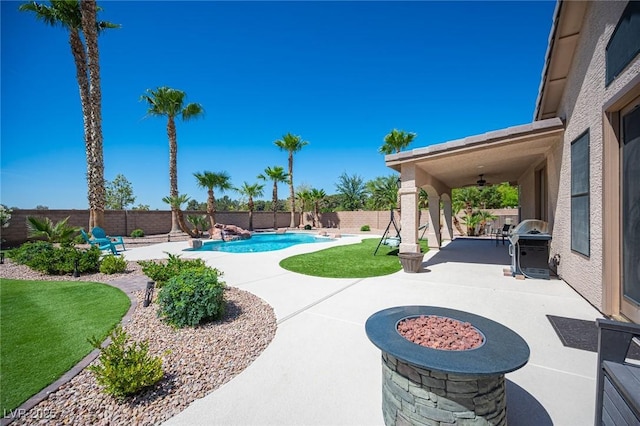 5815 Pristine Falls Ave, Las Vegas, NV 89131 - view of pool with a patio area, a ceiling fan, a fenced backyard, and area for grilling