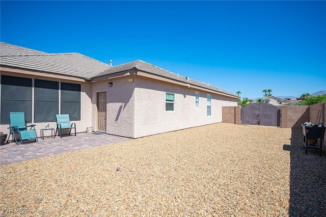 5815 Pristine Falls Ave, Las Vegas, NV 89131 - rear view of property featuring a gate, stucco siding, a fenced backyard, and a patio area