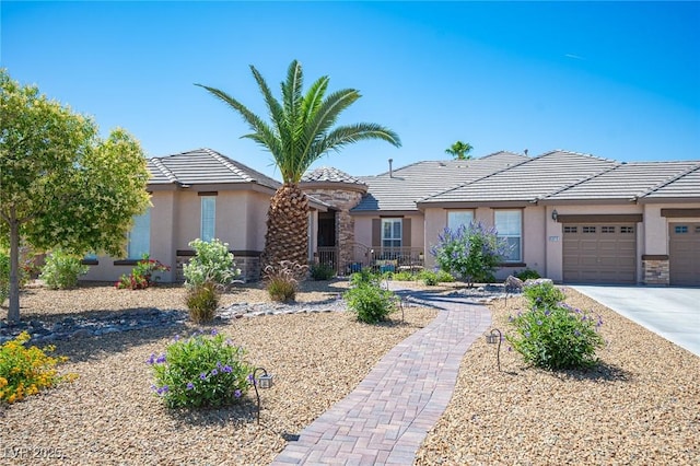 5815 Pristine Falls Ave, Las Vegas, NV 89131 - view of front of property with stucco siding, an attached garage, concrete driveway, a tiled roof, and stone siding