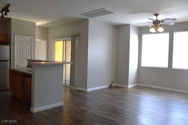 9303 Gilcrease Ave Unit 1097, Las Vegas, NV 89149 - kitchen with stainless steel dishwasher, a ceiling fan, dark wood-style flooring, visible vents, and freestanding refrigerator