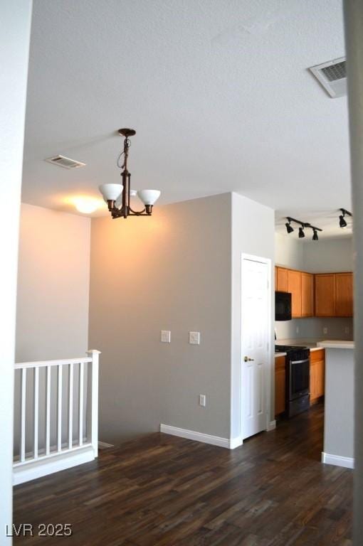 9303 Gilcrease Ave Unit 1097, Las Vegas, NV 89149 - interior space featuring black appliances, dark wood-style floors, visible vents, and light countertops