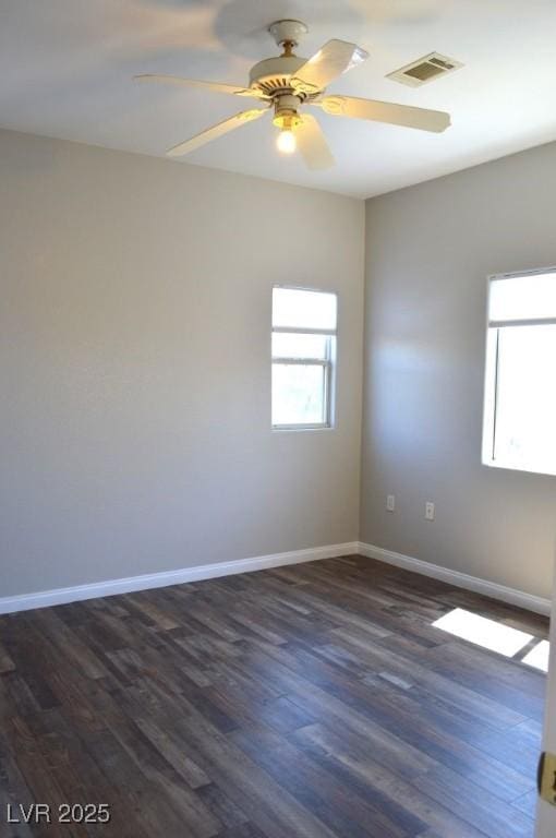 9303 Gilcrease Ave Unit 1097, Las Vegas, NV 89149 - unfurnished room featuring baseboards, a ceiling fan, visible vents, and dark wood-style flooring