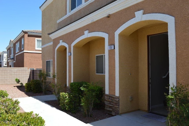 9303 Gilcrease Ave Unit 1097, Las Vegas, NV 89149 - property entrance with fence, a tile roof, and stucco siding