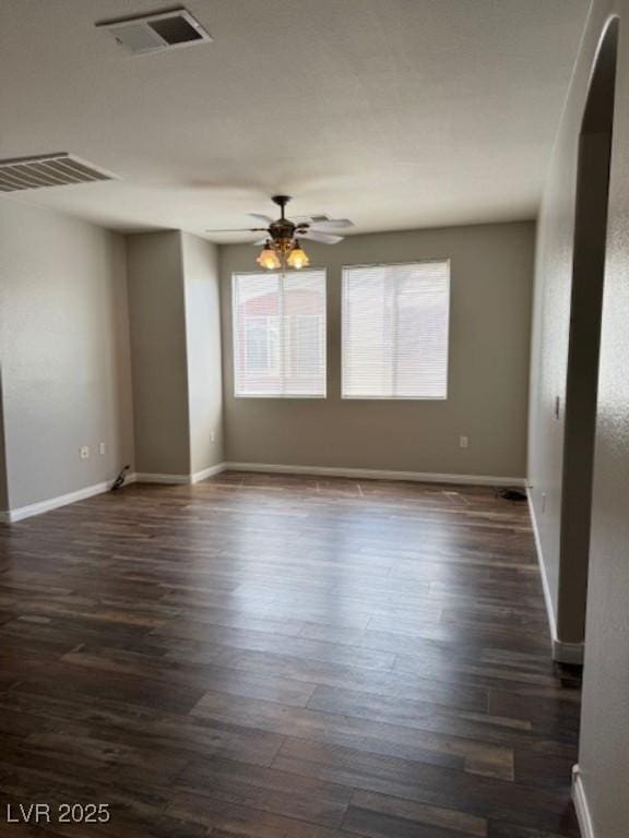 9303 Gilcrease Ave Unit 1097, Las Vegas, NV 89149 - spare room featuring dark wood finished floors, baseboards, a ceiling fan, and visible vents
