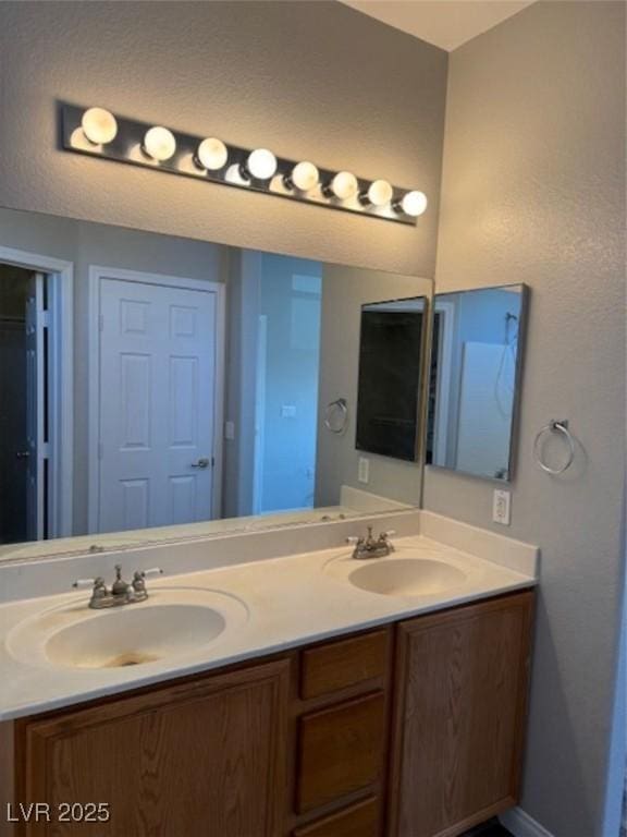 9303 Gilcrease Ave Unit 1097, Las Vegas, NV 89149 - full bath featuring baseboards, a sink, and double vanity