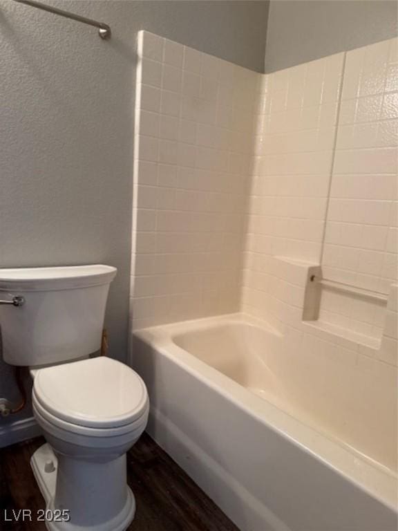 9303 Gilcrease Ave Unit 1097, Las Vegas, NV 89149 - full bathroom with a textured wall, wood finished floors, tub / shower combination, and toilet