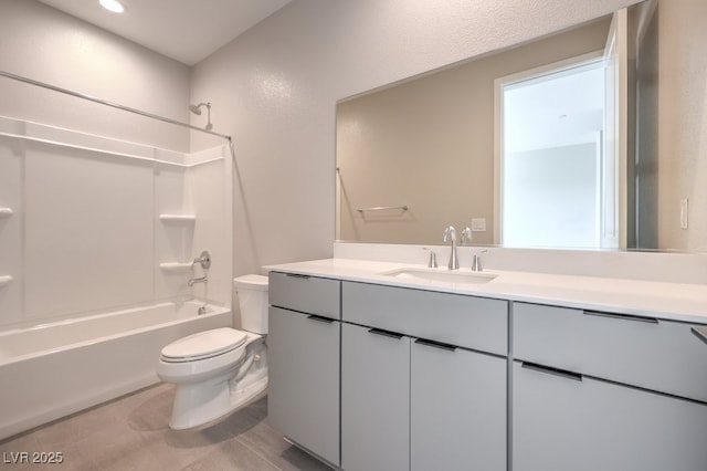 full bath with tile patterned floors, toilet, vanity, and shower / washtub combination