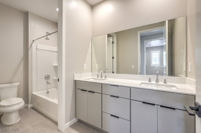 full bathroom with double vanity, toilet, shower / bathing tub combination, and a sink