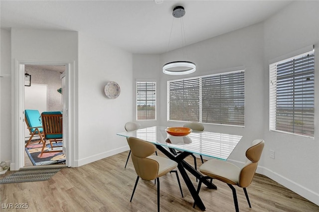 dining area featuring baseboards and wood finished floors
