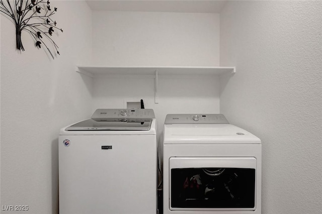 clothes washing area featuring laundry area and separate washer and dryer