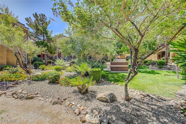 view of property's community with a lawn