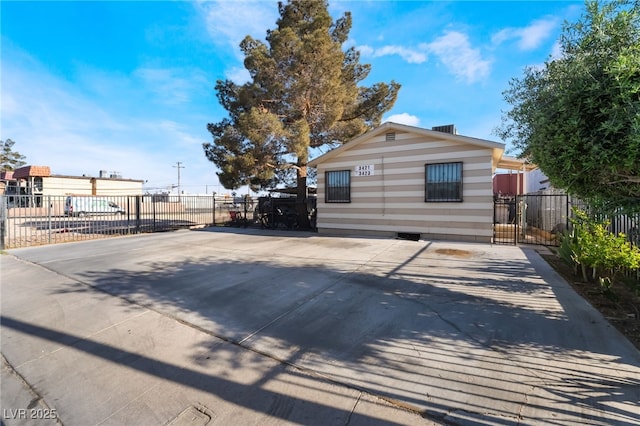 exterior space with crawl space, concrete driveway, and fence