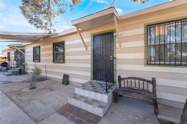 doorway to property with a patio area