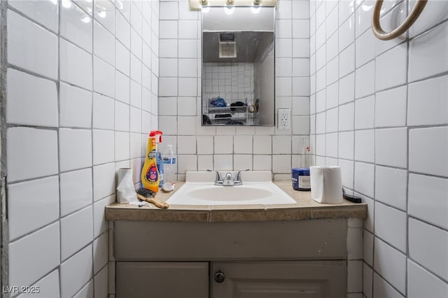bathroom with backsplash, tile walls, and vanity