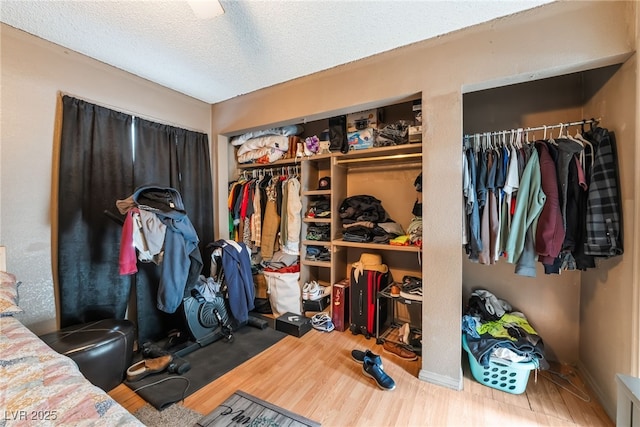 bedroom with a textured ceiling and wood finished floors