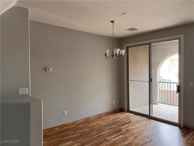 10067 Sand Key St, Las Vegas, NV 89178 - unfurnished dining area with wood finished floors and a chandelier