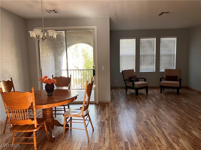 10067 Sand Key St, Las Vegas, NV 89178 - dining space with a chandelier and wood finished floors