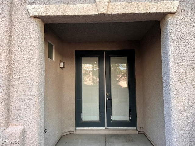10067 Sand Key St, Las Vegas, NV 89178 - view of exterior entry featuring stucco siding and french doors