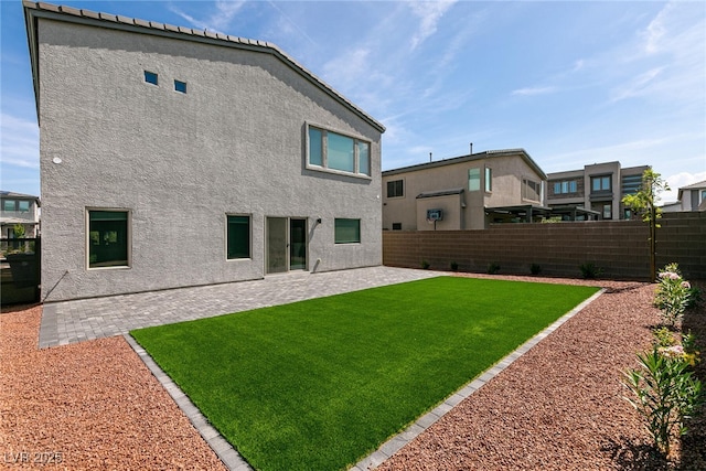 363 Terrill Ave, Las Vegas, NV 89183 - rear view of property with a fenced backyard, stucco siding, a yard, and a patio area