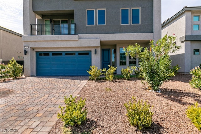 363 Terrill Ave, Las Vegas, NV 89183 - view of front of home with a balcony, driveway, stucco siding, and a garage