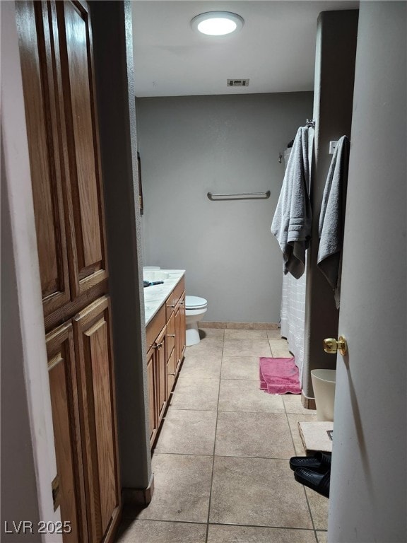 1812 Ivanhoe Way, Las Vegas, NV 89102 - bathroom featuring toilet, vanity, tile patterned flooring, and baseboards