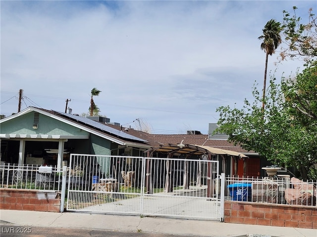 1812 Ivanhoe Way, Las Vegas, NV 89102 - view of front of house featuring solar panels, a gate, and stucco siding