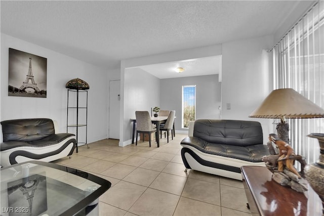 1440 Vegas Valley Dr Unit 1, Las Vegas, NV 89169 - living room with light tile patterned floors, a textured ceiling, and baseboards