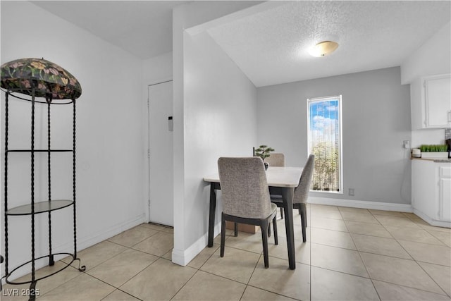 1440 Vegas Valley Dr Unit 1, Las Vegas, NV 89169 - dining room with baseboards, light tile patterned flooring, and a textured ceiling