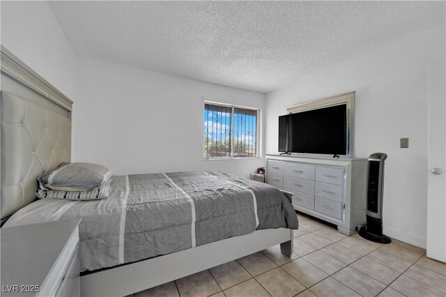 1440 Vegas Valley Dr Unit 1, Las Vegas, NV 89169 - bedroom with a textured ceiling and light tile patterned flooring
