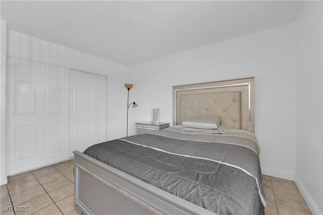 1440 Vegas Valley Dr Unit 1, Las Vegas, NV 89169 - bedroom featuring light tile patterned floors, baseboards, and a closet