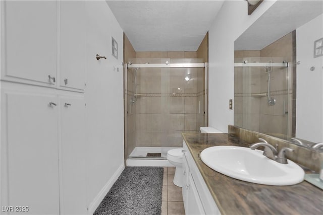 1440 Vegas Valley Dr Unit 1, Las Vegas, NV 89169 - full bathroom with a stall shower, vanity, toilet, and tile patterned floors