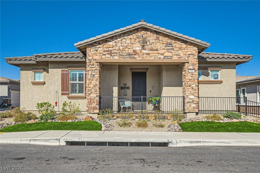 216 Bellini Peak Ave, Henderson, NV 89011 - view of front of home with a tile roof, stucco siding, and fence