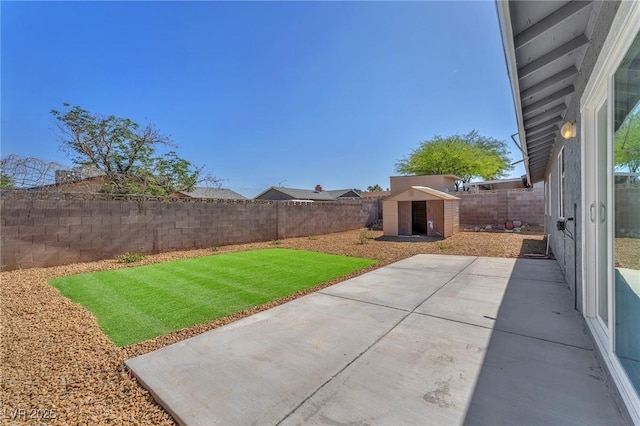 6770 Laronda Ln, Las Vegas, NV 89156 - fenced backyard with a patio area and a storage shed