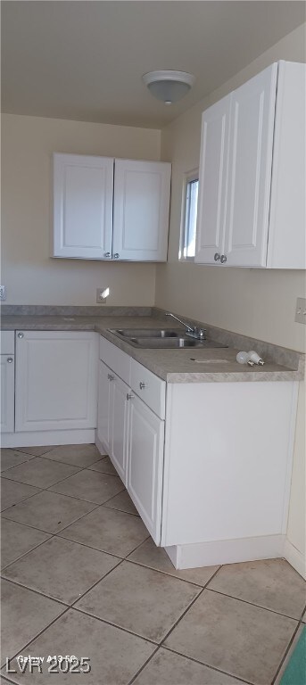 1832 Lewis Ave, Las Vegas, NV 89101 - kitchen with light tile patterned floors, a sink, and white cabinetry