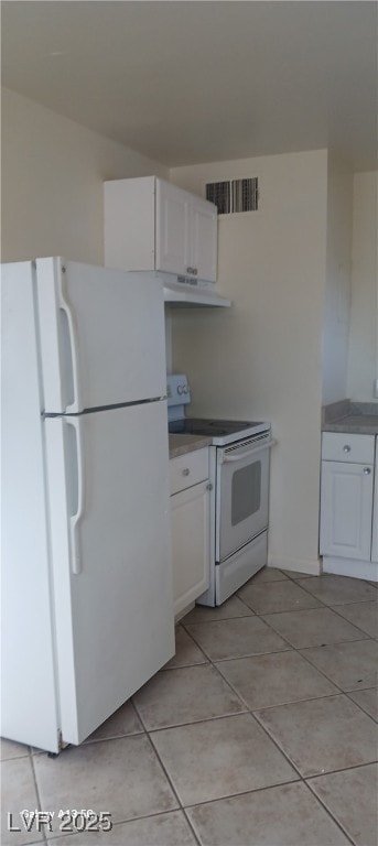 1832 Lewis Ave, Las Vegas, NV 89101 - kitchen featuring white appliances, light tile patterned floors, under cabinet range hood, white cabinets, and visible vents