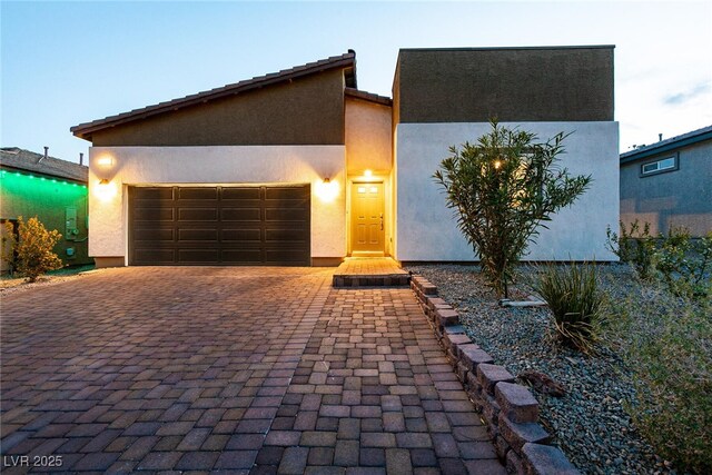 10125 Sequoia Falls Pl, Las Vegas, NV 89149 - view of front facade featuring decorative driveway, an attached garage, and stucco siding