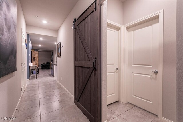 10125 Sequoia Falls Pl, Las Vegas, NV 89149 - hall with a barn door, light tile patterned floors, baseboards, and recessed lighting