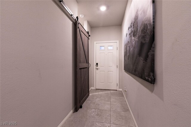 10125 Sequoia Falls Pl, Las Vegas, NV 89149 - hall with a barn door, baseboards, and light tile patterned floors