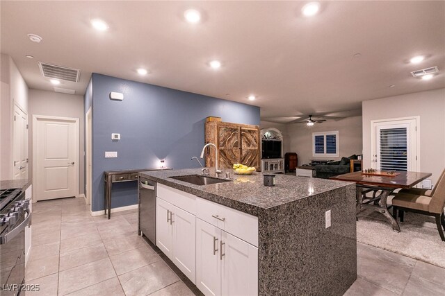 10125 Sequoia Falls Pl, Las Vegas, NV 89149 - kitchen with a sink, stainless steel appliances, ceiling fan, white cabinets, and dark stone counters