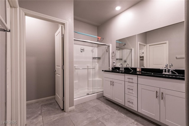 10125 Sequoia Falls Pl, Las Vegas, NV 89149 - bathroom with a stall shower, double vanity, recessed lighting, and baseboards