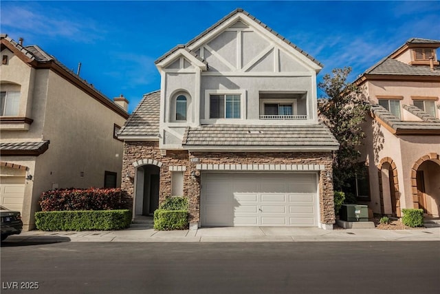 9173 Whitekirk Pl, Las Vegas, NV 89145 - view of front of property with stone siding, stucco siding, an attached garage, and concrete driveway