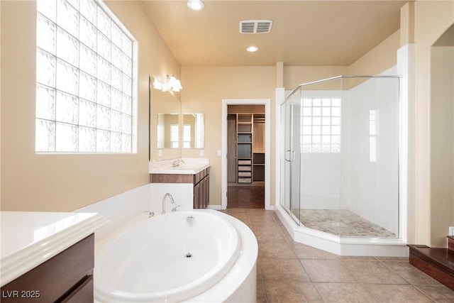 9173 Whitekirk Pl, Las Vegas, NV 89145 - bathroom with a shower stall, vanity, a bath, plenty of natural light, and recessed lighting