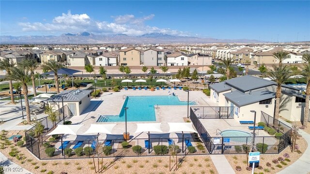 6804 Surf Green Ct, North Las Vegas, NV 89086 - aerial perspective of suburban area featuring a pool and a mountain backdrop