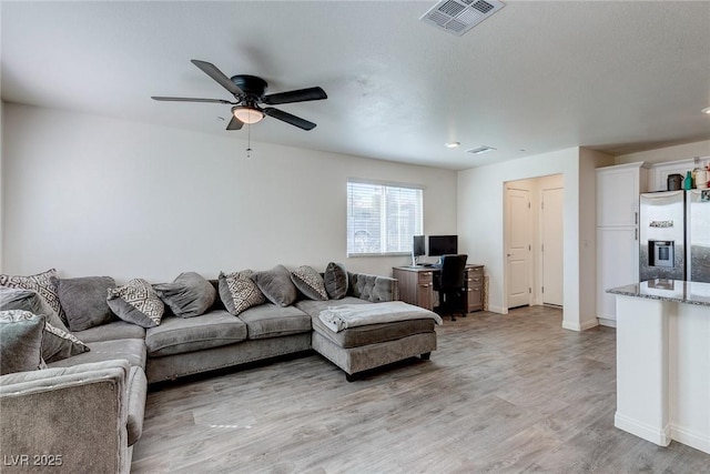 6804 Surf Green Ct, North Las Vegas, NV 89086 - living room with ceiling fan, light wood-type flooring, and baseboards