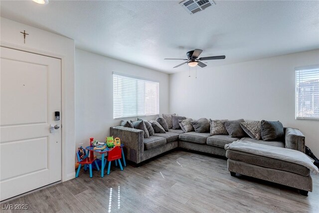 6804 Surf Green Ct, North Las Vegas, NV 89086 - living room with wood finished floors, a ceiling fan, and baseboards