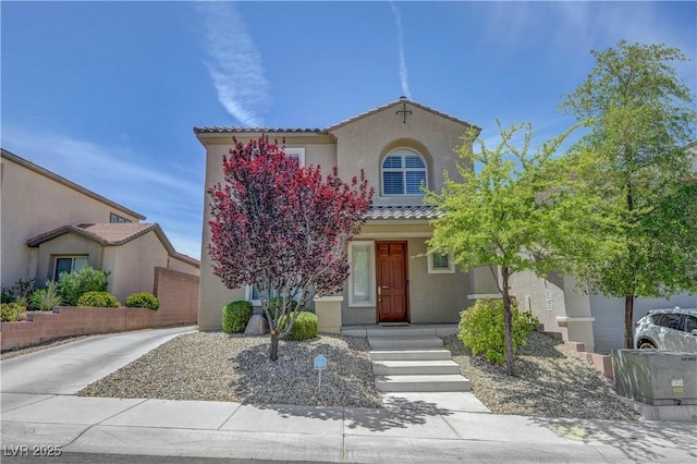 view of front of house featuring stucco siding and a tile roof
