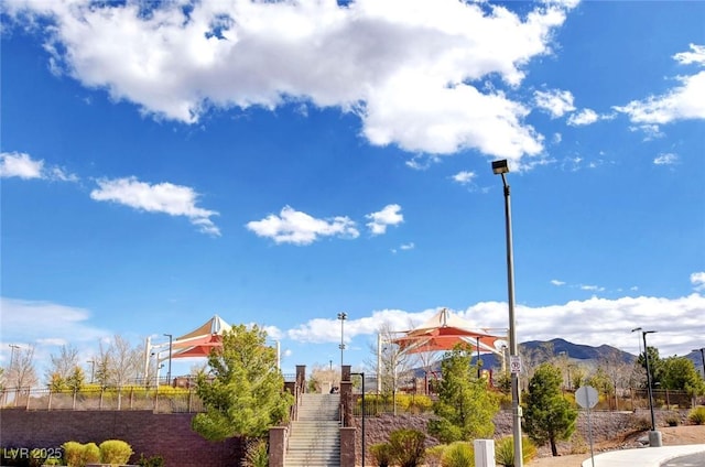 view of community featuring fence and a mountain view