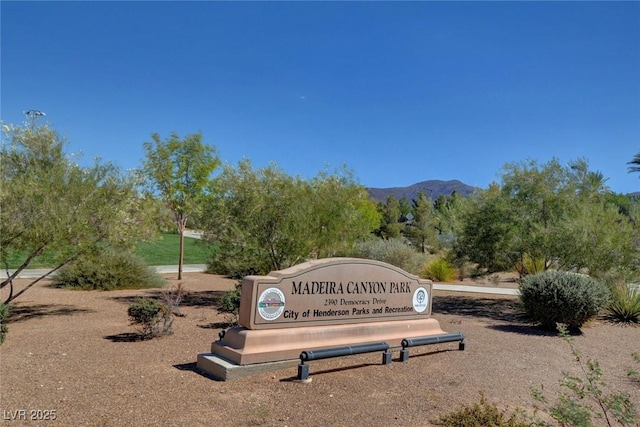 community sign with a mountain view